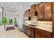 This kitchen showcases wood cabinets, stone countertops, an island with seating, and stainless steel appliances at 241 Russell Rd, Lawrenceville, GA 30043