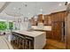 Spacious kitchen boasts a large island with seating, custom cabinetry, and modern pendant lighting at 241 Russell Rd, Lawrenceville, GA 30043