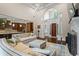 Spacious open-concept living area flowing into kitchen with coffered ceilings, hardwood floors, and fireplace at 241 Russell Rd, Lawrenceville, GA 30043