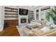 Inviting living room features a cozy fireplace, custom shelving, and abundant natural light at 241 Russell Rd, Lawrenceville, GA 30043