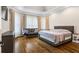 This main bedroom suite includes dark hardwood floors, a sitting area, and abundant natural light at 241 Russell Rd, Lawrenceville, GA 30043
