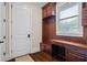 Functional mudroom with built-in storage, coat hooks, desk and natural light from window at 241 Russell Rd, Lawrenceville, GA 30043