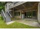 Lower level patio offers a cozy spot with brick accents, stairs to the deck, and outdoor storage at 241 Russell Rd, Lawrenceville, GA 30043