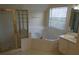 This is a tiled bathroom with a walk-in glass shower and a soaking tub at 804 Bridle Cove, Stockbridge, GA 30281