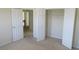 This bedroom has neutral walls, neutral carpeting, an open door, and a closet with bifold doors at 804 Bridle Cove, Stockbridge, GA 30281
