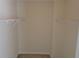 This walk-in closet has neutral walls, neutral carpeting, and wire shelving at 804 Bridle Cove, Stockbridge, GA 30281