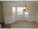 Elegant dining room with a bay window and stylish chandelier at 804 Bridle Cove, Stockbridge, GA 30281