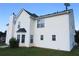 The home's exterior features white siding, a black roof, and manicured lawn under a blue sky at 804 Bridle Cove, Stockbridge, GA 30281