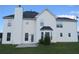 The home's exterior features white siding, a black roof, and manicured lawn under a blue sky at 804 Bridle Cove, Stockbridge, GA 30281