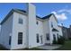 The home's exterior features white siding, a black roof, and manicured lawn under a blue sky at 804 Bridle Cove, Stockbridge, GA 30281