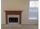 Fireplace with white marble hearth and carved wood mantle, illuminated by natural light at 804 Bridle Cove, Stockbridge, GA 30281