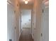 Hallway view with tile flooring and multiple white doors leading to various rooms at 804 Bridle Cove, Stockbridge, GA 30281