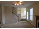 Open living room showcasing a carpeted staircase and view into the dining area at 804 Bridle Cove, Stockbridge, GA 30281