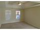 Spacious main bedroom with a tray ceiling, neutral carpet, and bright windows at 804 Bridle Cove, Stockbridge, GA 30281