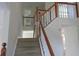 Carpeted staircase with white spindles and wood railing leads to the upper level at 804 Bridle Cove, Stockbridge, GA 30281