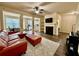 Open-concept living room with a fireplace, plush rug, modern furniture, and plenty of natural light at 2351 Attewood Dr, Buford, GA 30519
