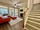 Open living space with fireplace, stairs to upper level, view of kitchen and dining area at 2351 Attewood Dr, Buford, GA 30519