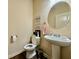 Well-lit powder room with neutral color scheme, pedestal sink, and decorative accents at 2351 Attewood Dr, Buford, GA 30519