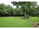 Expansive backyard with mature trees providing a serene backdrop, perfect for outdoor activities and relaxation at 236 Hiram Sudie Rd, Dallas, GA 30157