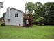 View of backyard with a deck, shed, and verdant trees at 236 Hiram Sudie Rd, Dallas, GA 30157