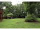 Spacious backyard with a small outbuilding and a fire pit at 236 Hiram Sudie Rd, Dallas, GA 30157