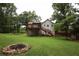 Large backyard features a two-level deck, a fire pit, and green landscaping at 236 Hiram Sudie Rd, Dallas, GA 30157