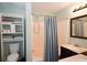 Bathroom with a shower-tub combo, storage shelves, and double vanity at 236 Hiram Sudie Rd, Dallas, GA 30157