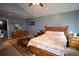 Cozy bedroom featuring wooden furniture set, ceiling fan, and a decorative rug at 236 Hiram Sudie Rd, Dallas, GA 30157