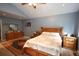 Cozy bedroom featuring wooden furniture set, ceiling fan, and a decorative rug at 236 Hiram Sudie Rd, Dallas, GA 30157