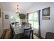 Bright dining room with a large table, elegant chandelier, and views of the outdoors, perfect for gatherings at 236 Hiram Sudie Rd, Dallas, GA 30157