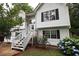 Charming two-story home featuring a welcoming front porch and beautifully landscaped yard with vibrant flowers at 236 Hiram Sudie Rd, Dallas, GA 30157