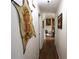 Hallway featuring hardwood floors and eye-catching wall decor and leading to a cozy living area at 236 Hiram Sudie Rd, Dallas, GA 30157