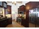 Modern kitchen with stainless steel appliances, dark wood cabinetry, and granite countertops at 236 Hiram Sudie Rd, Dallas, GA 30157