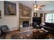 Comfortable living room featuring a stone fireplace, hardwood floors, and a ceiling fan for added comfort at 236 Hiram Sudie Rd, Dallas, GA 30157