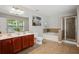 Bathroom featuring double sinks, a soaking tub, and a tiled shower with a glass door at 2840 Brookford Sw Ln, Atlanta, GA 30331