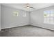 Bright bedroom featuring three windows, neutral colored walls and carpeting at 2840 Brookford Sw Ln, Atlanta, GA 30331