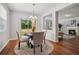 Light-filled dining area with wood floors, modern lighting, and view of outdoor space at 2840 Brookford Sw Ln, Atlanta, GA 30331