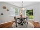 Eat-in kitchen with hardwood floors, modern chandelier and sliding glass door to back yard at 2840 Brookford Sw Ln, Atlanta, GA 30331