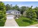 A two-story home with green lawn and mature trees. Has an attached two-car garage and cozy front porch at 2840 Brookford Sw Ln, Atlanta, GA 30331