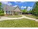 Charming home featuring a well-manicured front lawn, walkway, and inviting front porch at 2840 Brookford Sw Ln, Atlanta, GA 30331