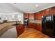 Bright kitchen featuring cherry cabinets, granite countertops, stainless appliances, and wood floors at 2840 Brookford Sw Ln, Atlanta, GA 30331