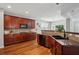Spacious kitchen with cherry cabinets, granite countertops, black appliances, and wood floors at 2840 Brookford Sw Ln, Atlanta, GA 30331