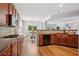 Kitchen with hardwood floors, wooden cabinets, granite countertops, and stainless-steel appliances at 2840 Brookford Sw Ln, Atlanta, GA 30331