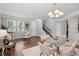 Open living room with hardwood floors, dining table, staircase, and lots of natural light at 2840 Brookford Sw Ln, Atlanta, GA 30331