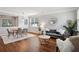 Living room with hardwood floors, neutral walls, dining table, gray couch, and modern decor at 2840 Brookford Sw Ln, Atlanta, GA 30331