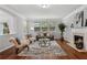 Bright living room with hardwood floors, fireplace, a gray sofa, and elegant furniture at 2840 Brookford Sw Ln, Atlanta, GA 30331