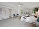 Bright main bedroom featuring soft gray walls, decorative furniture, and tray ceilings at 2840 Brookford Sw Ln, Atlanta, GA 30331