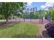 The community tennis court is surrounded by a tall fence and lush greenery, offering a private playing experience at 2840 Brookford Sw Ln, Atlanta, GA 30331