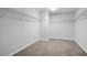 Empty walk-in closet with wire shelving and neutral colored carpeting at 2840 Brookford Sw Ln, Atlanta, GA 30331