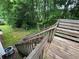 Wooden stairs leading down to a wooded backyard at 134 Summer Lake Dr, Dallas, GA 30157